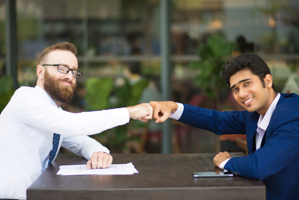 cheerful business partners making fist bump 2