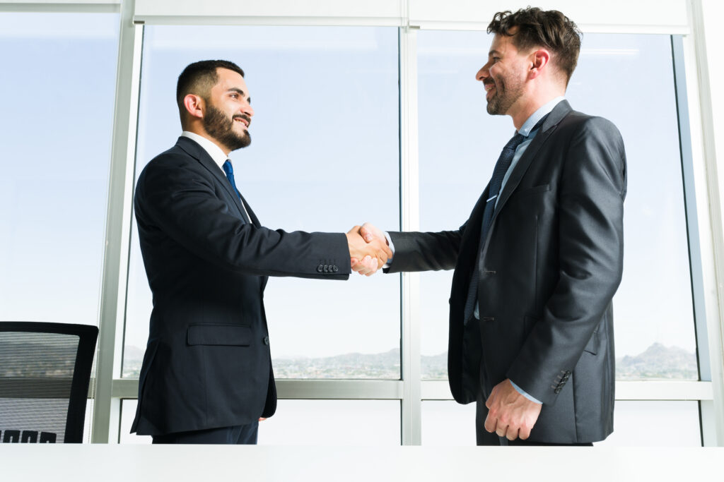 building collaborative teamwork handsome businessman business executive getting know each other while shaking hands work meeting